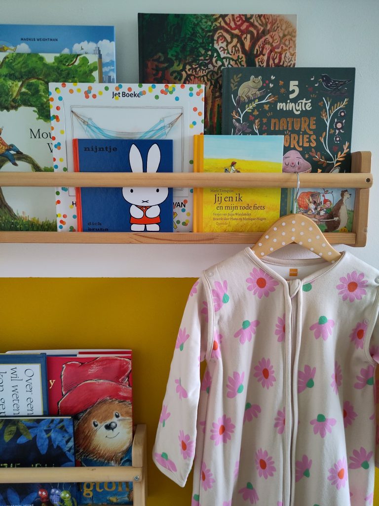 A children's sleeping bag laid out on a bed.